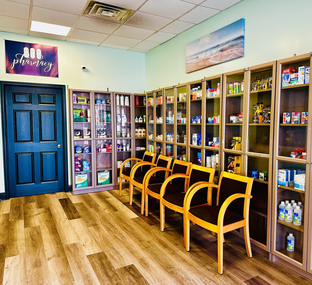 pharmacist greeting a patient inside Healthfirst Pharmacy